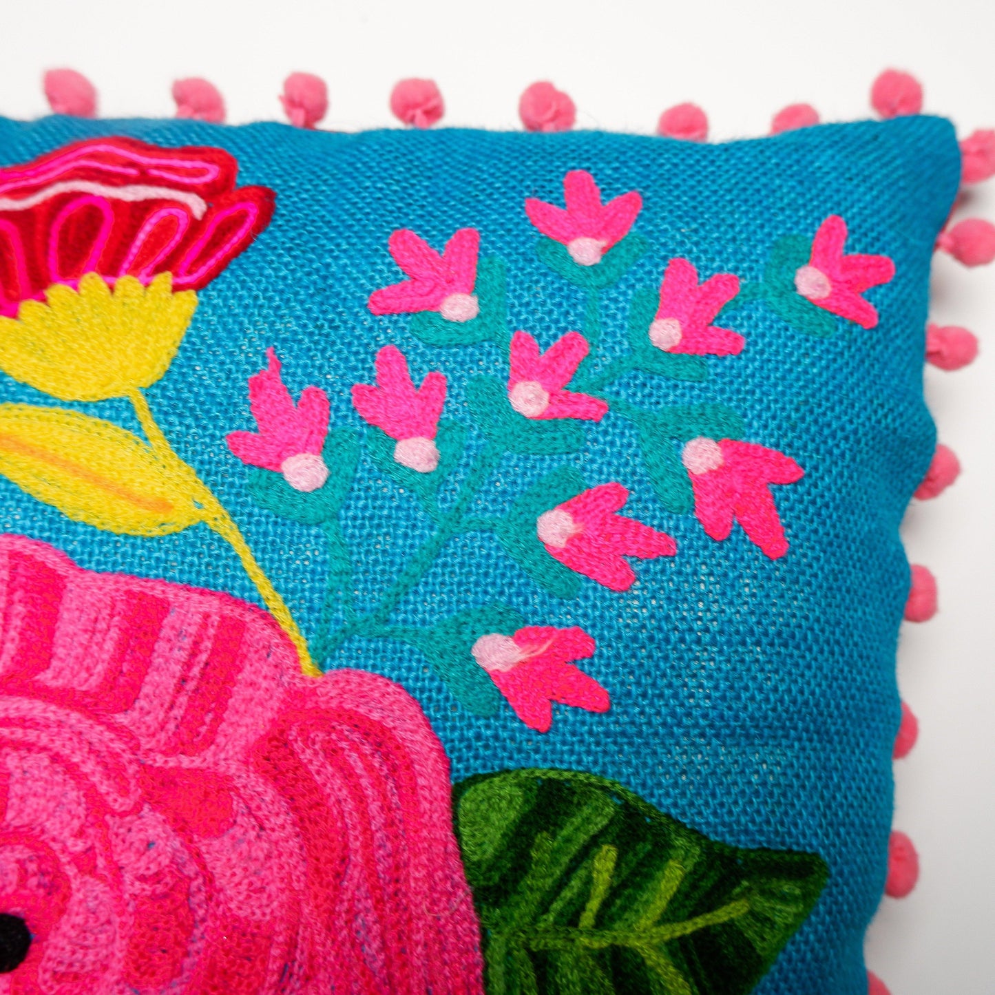 Embroidered Flower Cushion with Pom Poms - Vendeo.co.uk